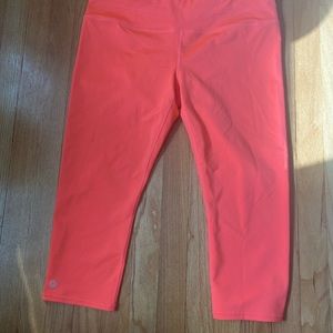 Bright orange Athleta mid-calf leggings